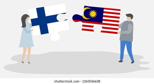 Couple holding two puzzles pieces with Finnish and Malaysian flags. Finland and Malaysia national symbols together.