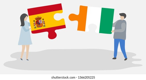 Couple holding two puzzles pieces with Spanish and Ivorian flags. Spain and Ivory Coast national symbols together.