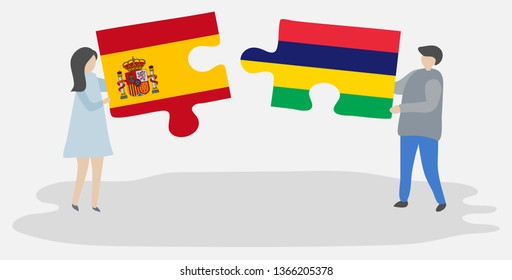 Couple holding two puzzles pieces with Spanish and Mauritian flags. Spain and Mauritius national symbols together.