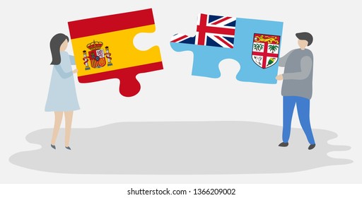 Couple holding two puzzles pieces with Spanish and Fijian flags. Spain and Fiji national symbols together.