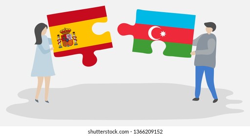 Couple holding two puzzles pieces with Spanish and Azerbaijani flags. Spain and Azerbaijan national symbols together.