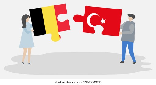 Couple holding two puzzles pieces with Belgian and Turkish flags. Belgium and Turkey national symbols together.