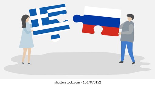 Couple holding two puzzles pieces with Greek and Russian flags. Greece and Russia national symbols together.