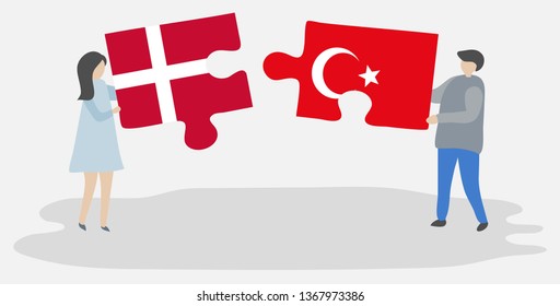 Couple holding two puzzles pieces with Danish and Turkish flags. Denmark and Turkey national symbols together.