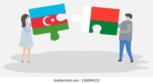 Couple holding two puzzles pieces with Azerbaijani and Malagasy flags. Azerbaijan and Madagascar national symbols together.