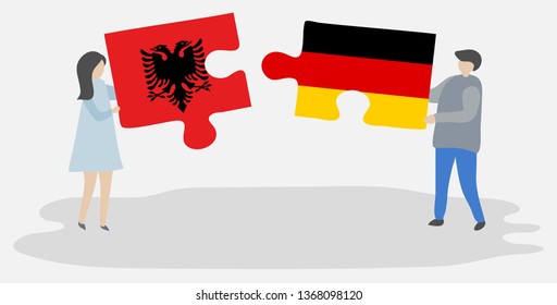 Couple holding two puzzles pieces with Albanian and German flags. Albania and Germany national symbols together.