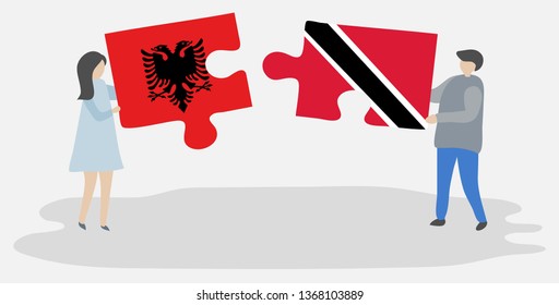 Couple holding two puzzles pieces with Albanian and Trinidadian flags. Albania and Trinidad and Tobago national symbols together.