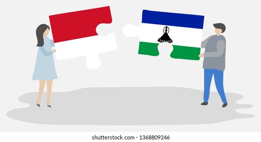 Couple holding two puzzles pieces with Indonesian and Basotho flags. Indonesia and Lesotho national symbols together.