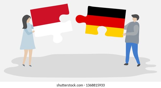 Couple holding two puzzles pieces with Indonesian and German flags. Indonesia and Germany national symbols together.