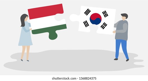 Couple holding two puzzles pieces with Hungarian and South Korean flags. Hungary and South Korea national symbols together.