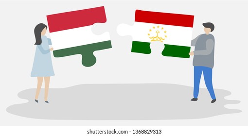 Couple holding two puzzles pieces with Hungarian and Tajikistani flags. Hungary and Tajikistan national symbols together.
