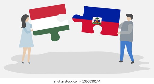 Couple holding two puzzles pieces with Hungarian and Haitian flags. Hungary and Haiti national symbols together.