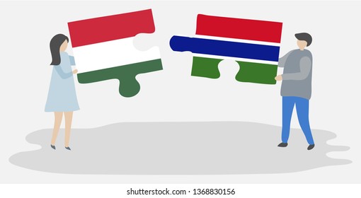 Couple holding two puzzles pieces with Hungarian and Gambian flags. Hungary and Gambia national symbols together.
