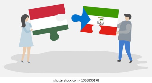 Couple holding two puzzles pieces with Hungarian and Equatorial Guinean flags. Hungary and Equatorial Guinea national symbols together.