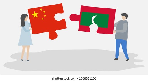 Couple holding two puzzles pieces with Chinese and Maldivian flags. China and Maldives national symbols together.