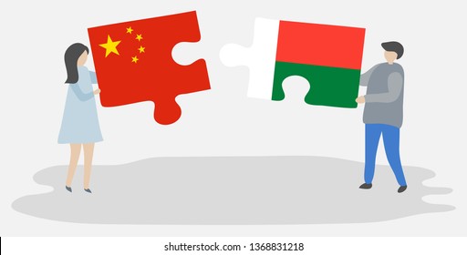 Couple holding two puzzles pieces with Chinese and Malagasy flags. China and Madagascar national symbols together.