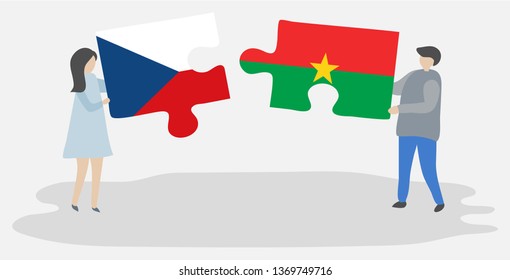 Couple holding two puzzles pieces with Czech and Burkinabe flags. Czech Republic and Burkina Faso national symbols together.