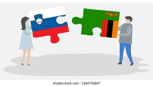 Couple holding two puzzles pieces with Slovenian and Zambian flags. Slovenia and Zambia national symbols together.