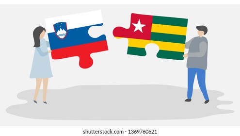 Couple holding two puzzles pieces with Slovenian and Togolese flags. Slovenia and Togo national symbols together.