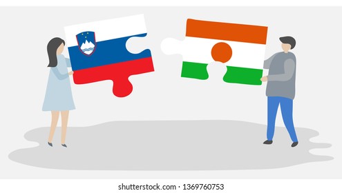 Couple holding two puzzles pieces with Slovenian and Nigerien flags. Slovenia and Niger national symbols together.