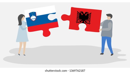 Couple holding two puzzles pieces with Slovenian and Albanian flags. Slovenia and Albania national symbols together.