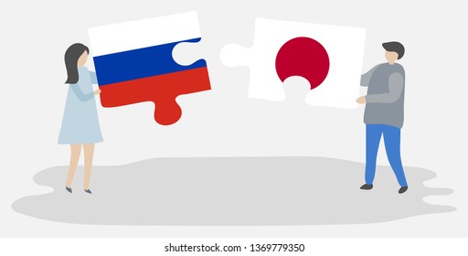 Couple holding two puzzles pieces with Russian and Japanese flags. Russia and Japan national symbols together.