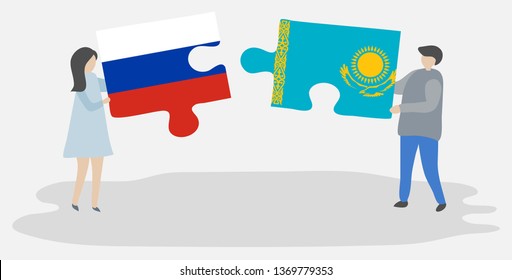 Couple holding two puzzles pieces with Russian and Kazakh flags. Russia and Kazakhstan national symbols together.