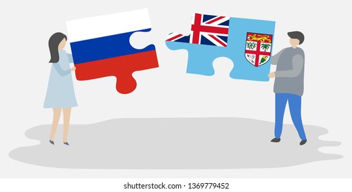 Couple holding two puzzles pieces with Russian and Fijian flags. Russia and Fiji national symbols together.