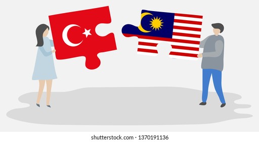 Couple holding two puzzles pieces with Turkish and Malaysian flags. Turkey and Malaysia national symbols together.