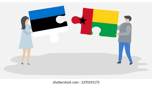 Couple holding two puzzles pieces with Estonian and Bissau-Guinean flags. Estonia and Guinea-Bissau national symbols together.