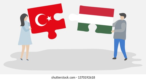 Couple holding two puzzles pieces with Turkish and Hungarian flags. Turkey and Hungary national symbols together.