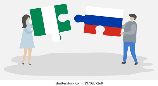 Couple holding two puzzles pieces with Nigerian and Russian flags. Nigeria and Russia national symbols together.