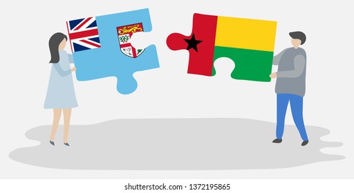 Couple holding two puzzles pieces with Fijian and Bissau-Guinean flags. Fiji and Guinea-Bissau national symbols together.