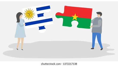 Couple holding two puzzles pieces with Uruguayan and Burkinabe flags. Uruguay and Burkina Faso national symbols together.