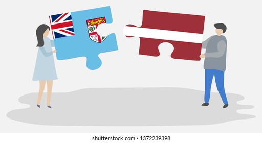 Couple holding two puzzles pieces with Fijian and Latvian flags. Fiji and Latvia national symbols together.