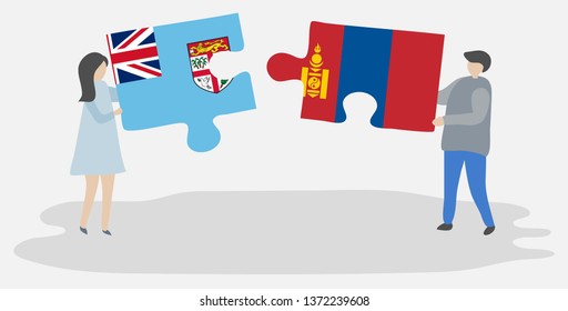 Couple holding two puzzles pieces with Fijian and Mongolian flags. Fiji and Mongolia national symbols together.