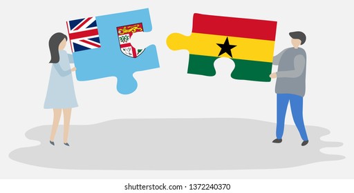 Couple holding two puzzles pieces with Fijian and Ghanaian flags. Fiji and Ghana national symbols together.