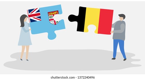 Couple holding two puzzles pieces with Fijian and Belgian flags. Fiji and Belgium national symbols together.