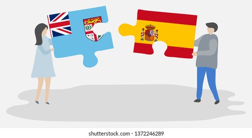Couple holding two puzzles pieces with Fijian and Spanish flags. Fiji and Spain national symbols together.