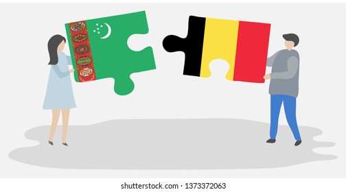 Couple holding two puzzles pieces with Turkmen and Belgian flags. Turkmenistan and Belgium national symbols together.