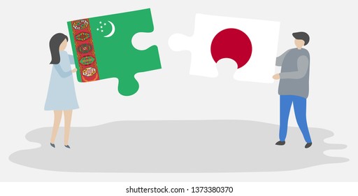 Couple holding two puzzles pieces with Turkmen and Japanese flags. Turkmenistan and Japan national symbols together.
