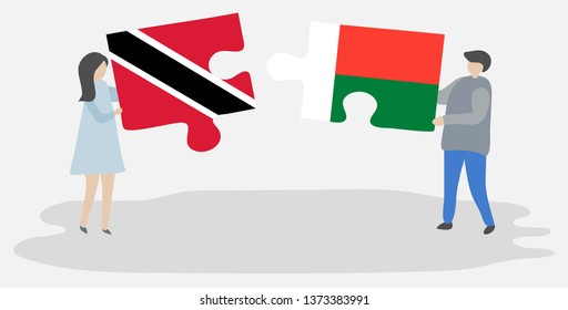 Couple holding two puzzles pieces with Trinidadian and Malagasy flags. Trinidad and Tobago and Madagascar national symbols together.