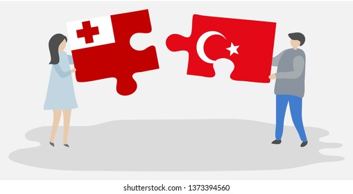Couple holding two puzzles pieces with Tongan and Turkish flags. Tonga and Turkey national symbols together.