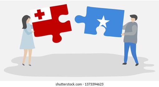 Couple holding two puzzles pieces with Tongan and Somali flags. Tonga and Somalia national symbols together.