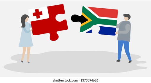 Couple holding two puzzles pieces with Tongan and South African flags. Tonga and South Africa national symbols together.