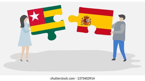Couple holding two puzzles pieces with Togolese and Spanish flags. Togo and Spain national symbols together.