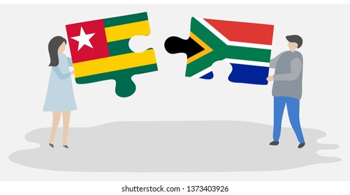 Couple holding two puzzles pieces with Togolese and South African flags. Togo and South Africa national symbols together.