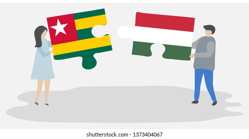Couple holding two puzzles pieces with Togolese and Hungarian flags. Togo and Hungary national symbols together.