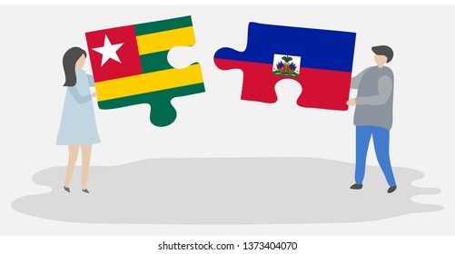 Couple holding two puzzles pieces with Togolese and Haitian flags. Togo and Haiti national symbols together.