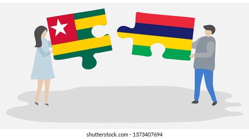 Couple holding two puzzles pieces with Togolese and Mauritian flags. Togo and Mauritius national symbols together.